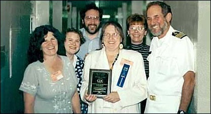 Deborah L. Wexler, MD, shown holding the award, is accompanied by (left to right) Margaret Vaillancourt and Lynn Bahta of the Coalition, and CDC's Hepatitis Branch staff members, Craig Shapiro, MD, medical epidemiologist; Linda Moyer, MSN, nurse epidemiologist; and Harold Margolis, MD, Hepatitis Branch chief
